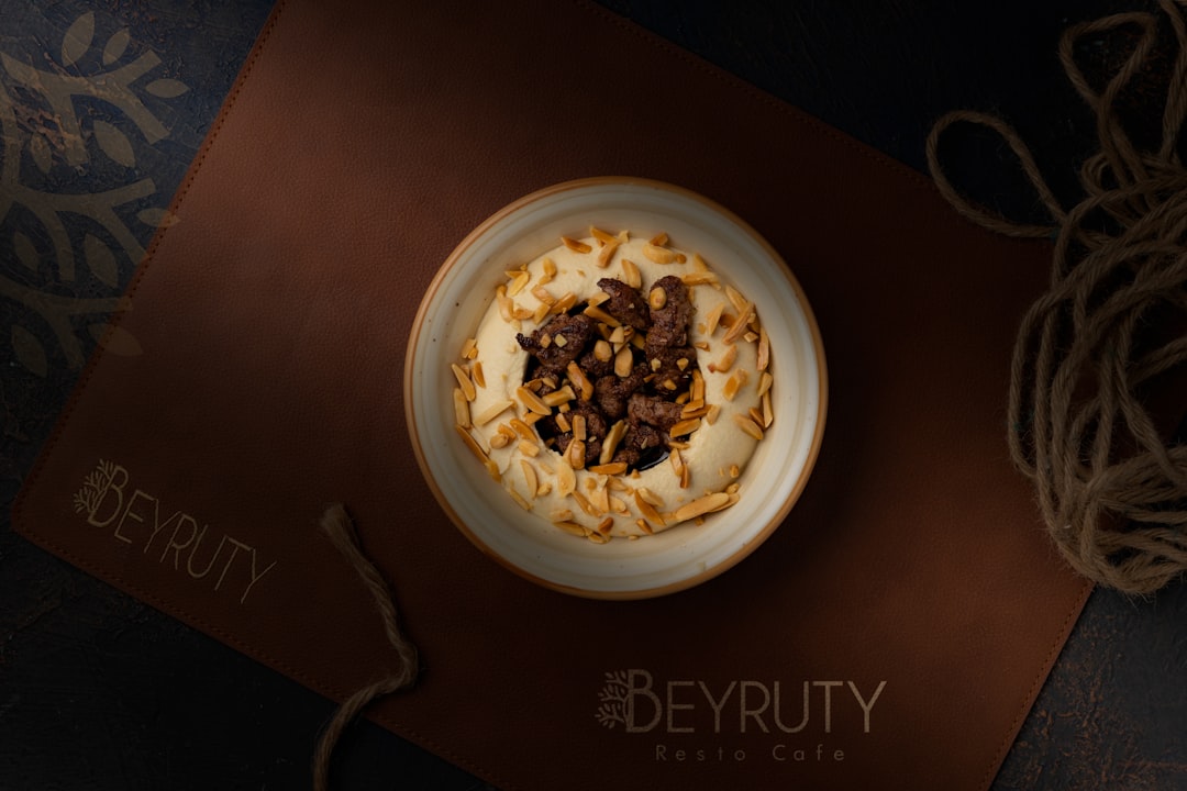 Creamy hummus topped with seasoned meat and nuts