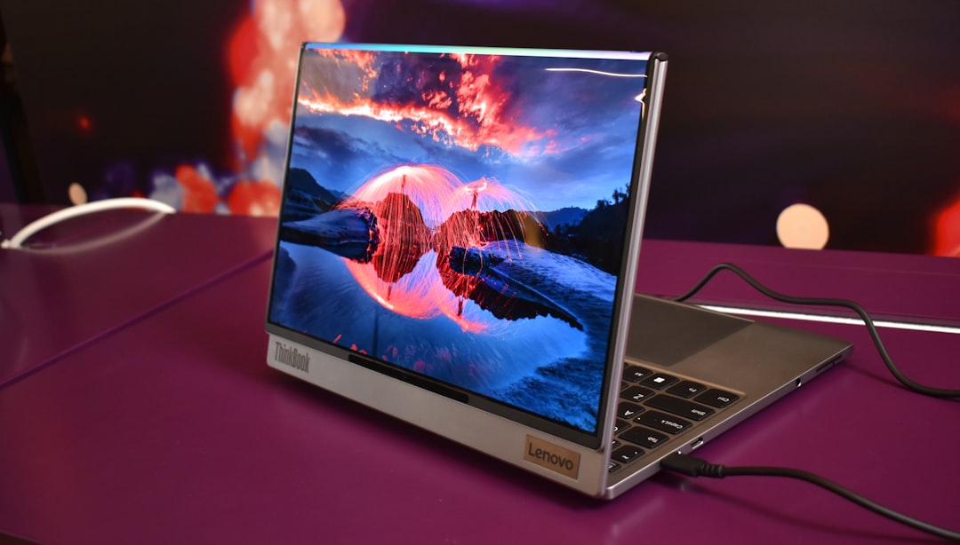 Modern laptop displaying a vibrant landscape on screen.
