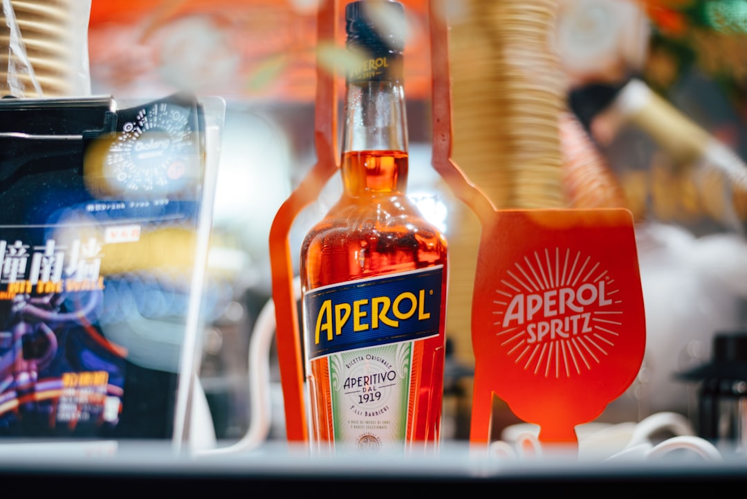 A bottle of aperol and a glass of aperol spritz