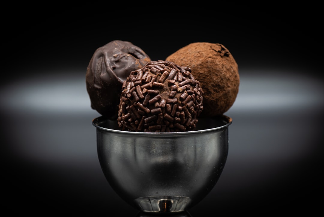 a metal bowl filled with different types of chocolates