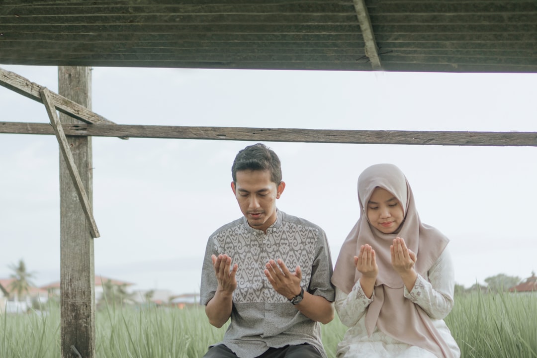 a man and a woman sitting on a bench